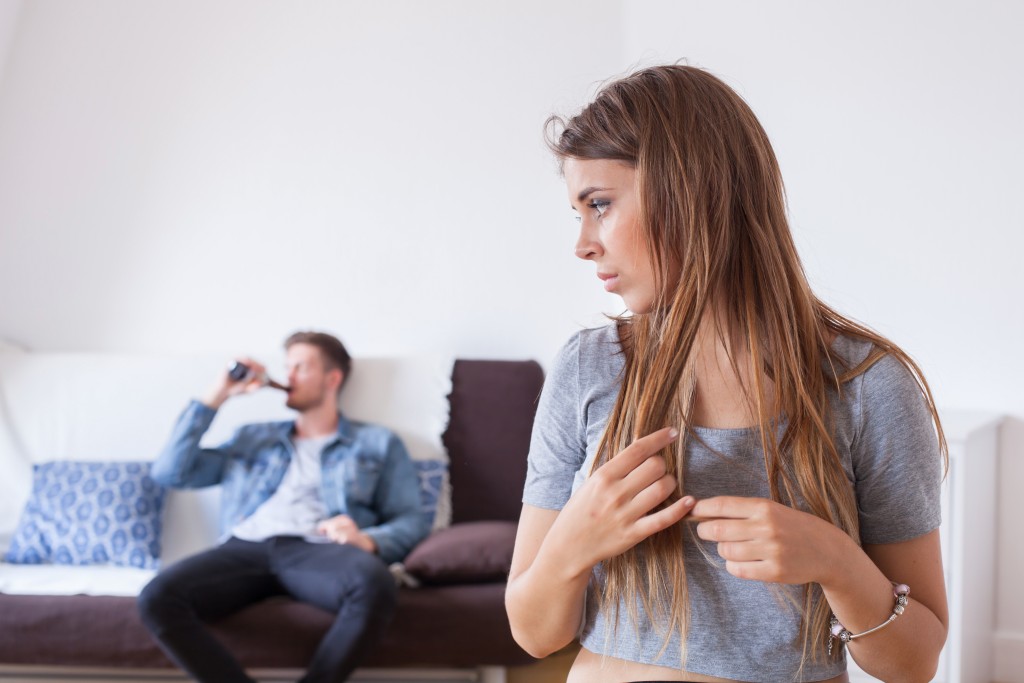 worried woman and drinking man