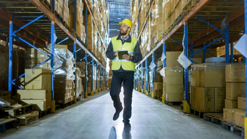 man inspecting the inside of a warehouse