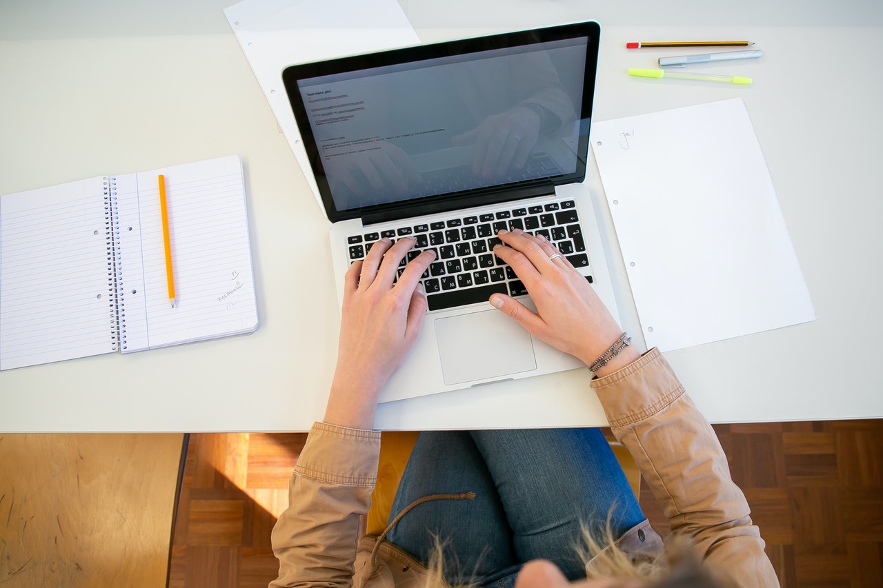 person writing an article on her laptop