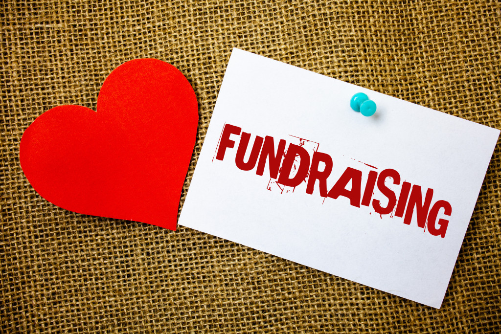 heart symbol beside a pinned envelope with fundraising printed on it